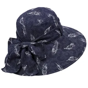 Navy blue foldable sun hat with white feather patterns and decorative side bow