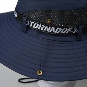 Detail of dark blue sun hat with breathable mesh, stitching, and metal snap button