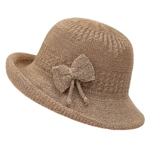 Brown knitted bucket hat for women with bow detail and vintage sun protection style