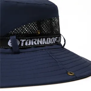 Detail of dark blue sun hat featuring breathable black mesh and embroidered ribbon