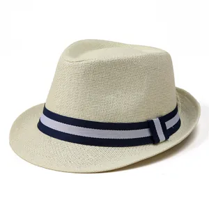Detail of a beige woven straw fedora with navy and white striped grosgrain ribbon band