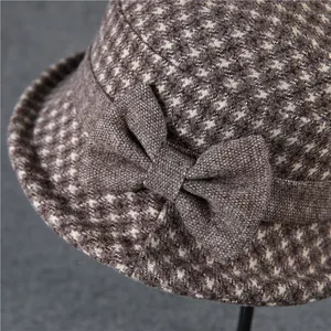 Close-up of retro brown houndstooth wool hat with detailed side bow decoration
