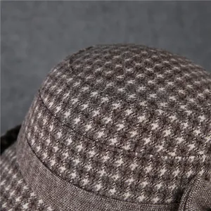 Macro detail of warm houndstooth wool fabric and stitching on a vintage basin hat