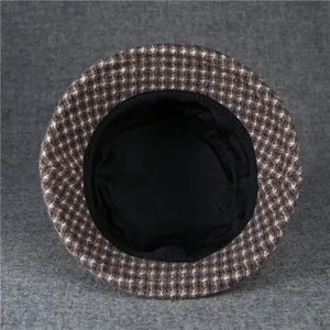 Detail of wool cloche hat with houndstooth pattern and black fabric lining inside