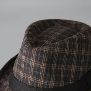 Close-up of vintage brown plaid tweed fedora hat with elegant black grosgrain ribbon band