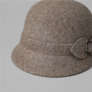 Close-up of wool cloche hat for women with elegant metal buckle and rhinestone detail