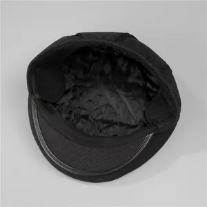 Detail view of winter flat cap showing quilted lining and foldable ear protection flaps