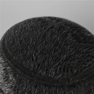 Detailed macro view of high-quality thick dark faux fur on the winter hat crown