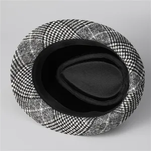 Detail view of the black and white checkered fedora hat interior lining and fabric texture