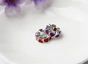 Close-up of red and purple enamel heart beads for DIY jewelry bracelets and necklaces