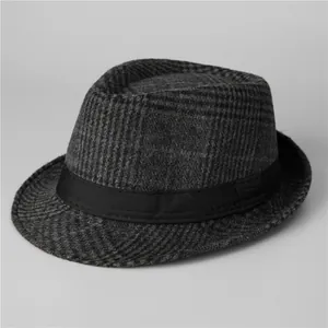 Detail of grey plaid fedora wool hat with black decorative ribbon and textured surface