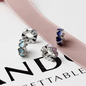 DIY enamel heart charms in light blue, white, pink, and navy blue for beaded bracelets