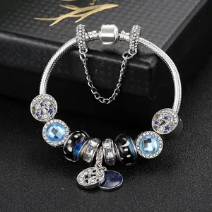 Detail of S925 silver snake chain bracelet with blue galaxy charms and star pendants