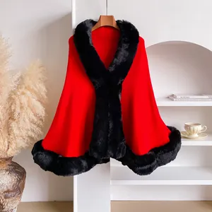 Detail of red knit shawl with luxurious black faux fur collar on wooden hanger