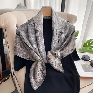 Detailed view of silk square scarf featuring black and white zebra and floral print patterns