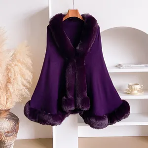 Detail of dark purple cape with thick faux rabbit fur trim on neck and hemline