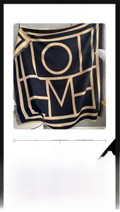 Detail of navy blue cashmere-feel shawl with geometric letters and fringed edges