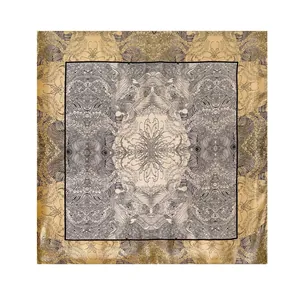Detail of luxury silk square scarf featuring champagne gold borders and phoenix patterns