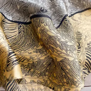 Luxurious gold silk square scarf with elegant botanical prints and geometric patterns