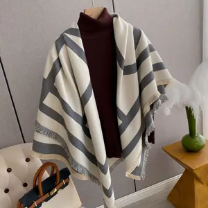 Close-up of geometric pattern cashmere shawl with thick stripes and soft fringed edges