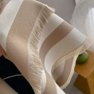 Elegant beige and white striped cashmere-like scarf with fringe details for autumn and winter