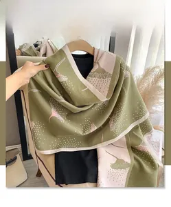 Close-up of olive green and pink dandelion scarf showing thick cashmere-like texture