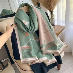 Detail of floral dandelion pattern and soft tassels on thick cashmere-like scarf