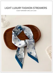 Detailed view of floral silk scarf accessory elegantly arranged on a wooden tray