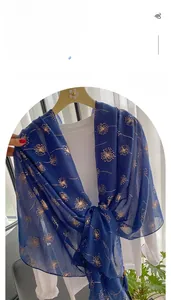 Detail of dark blue linen scarf with gold dandelion print and breathable fabric