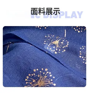 Detail of dark blue cotton linen fabric with gold dandelion patterns and textured weave