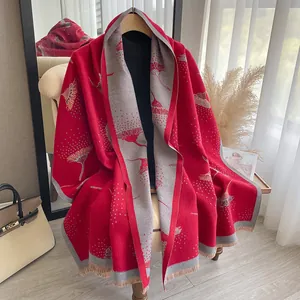 Close-up of red and grey pashmina shawl featuring dandelion jacquard and fringe details
