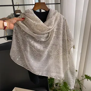 Detail showing snake print linen scarf with silver sequins and elegant tassel edges