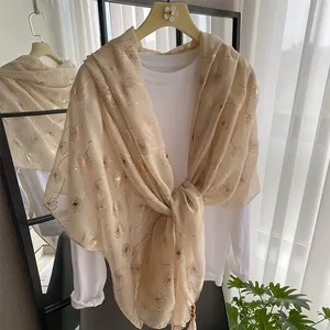 Beige floral scarf with golden dandelion prints and fringe details for sun protection