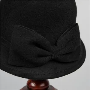 Close-up of the elegant wool felt bucket hat featuring a large decorative bow detail