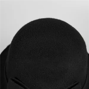 Close-up of black wool felt texture and fine stitching on a vintage cloche bucket hat