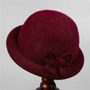 Detail view of wine red velvet bucket hat with bow accent and warm lining for elderly women