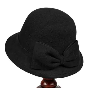 Elegant black wool cloche hat with a large bow decoration for a vintage Hepburn style