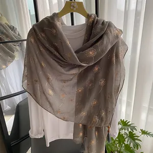 Detail of mocha brown summer scarf with gold dandelion foil print and beaded tassels