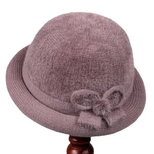 Plush purple winter bucket hat for elderly women with knitted bow and warm fleece lining