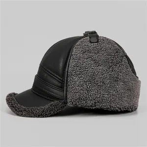 Winter men's thermal trapper hat with black leather exterior and grey faux fur lining