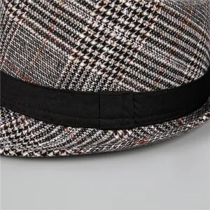 Detailed view of British style houndstooth wool trilby hat with black ribbon band decoration