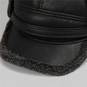 Detailed view of black faux leather and grey faux fur lining on a winter thermal trapper hat