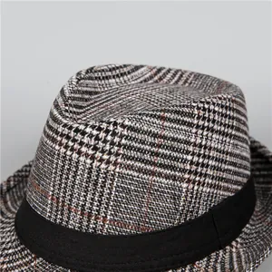 Close-up of a classic houndstooth fedora hat for men with black ribbon and wool texture