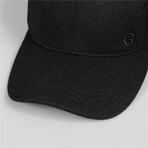 Detailed view of the black winter baseball cap featuring knit texture and G. embroidery