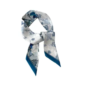 Elegant floral print skinny silk scarf in ivory and navy blue with diagonal hemmed edges