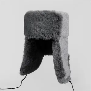 Detailed view of the thick faux fur lining and woolen earflaps on the winter trapper hat