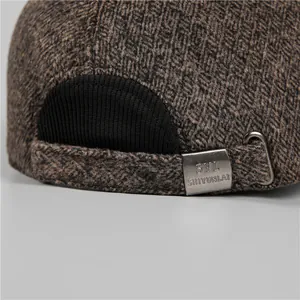 Detailed macro of the brown wool baseball cap with an adjustable engraved metal buckle