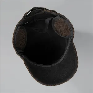 Detailed view of the herringbone wool texture and fleece lining on the ear flaps