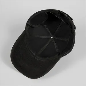 Detailed interior of black winter baseball cap showing sturdy stitching and adjustable strap