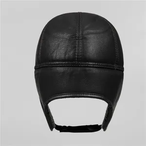 Close-up of black faux leather winter trapper hat with detailed stitching and ear flaps